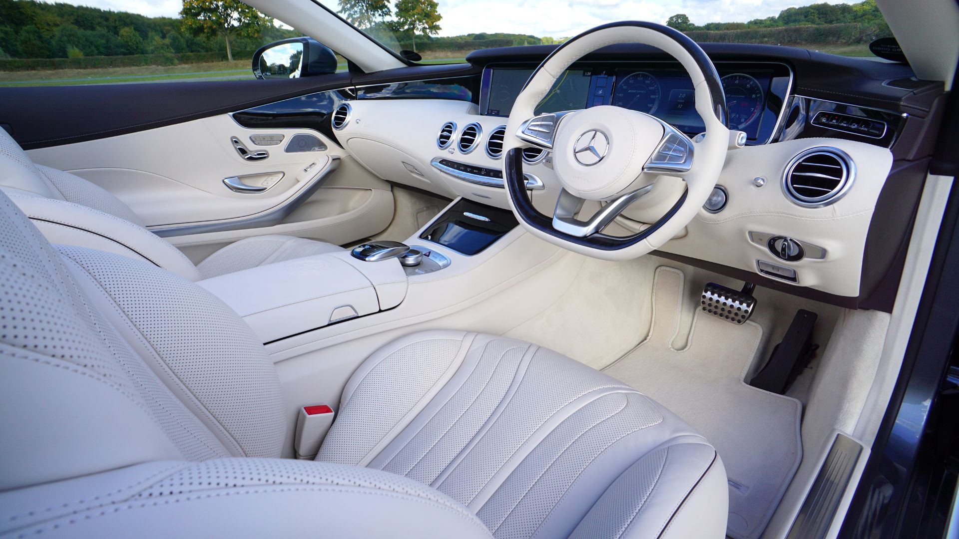Luxurious white Mercedes-Benz interior with leather seats and steering wheel